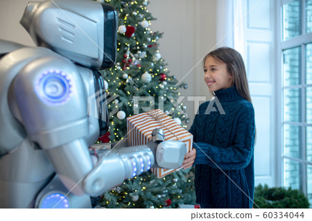 Robot giving a present to a smiling girl Robot giving a present to a smiling girl 60334044