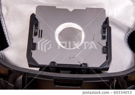 A close-up view of open vacuum cleaner with empty bag for dirt. A close-up view of open vacuum cleaner with empty bag for dirt. 60334053