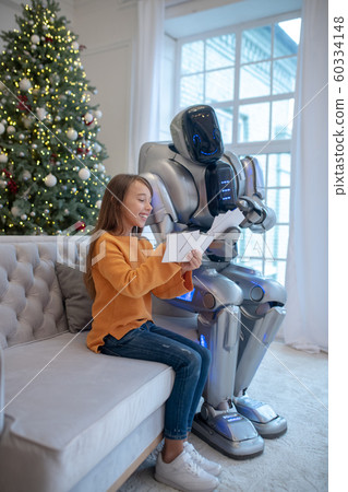Robot and a cute girl sitting on the sofa 60334148