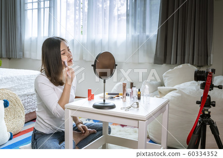 A beautiful Asian girl who is a beauty blogger is A beautiful Asian girl who is a beauty blogger is 60334352