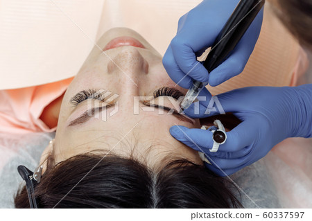 Permanent makeup, tattooing of eyebrows. 60337597