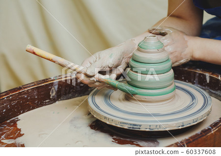 Hands on pottery wheel. Craftsman artist painting 60337608