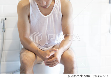 Close up man stomachache with toilet 60337884