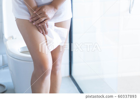 Close up woman stomachache with toilet  60337893