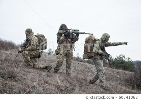 Military army soldiers team members patrolling area 60341068