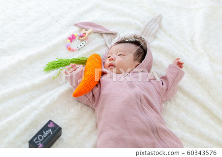 Baby wearing a rabbit costume Baby wearing a rabbit costume 60343576