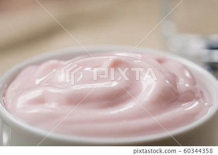 strawberry yogurt in white bowl closeup shot 60344358
