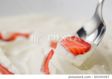 Closeup of eating fresh chopped strawberries with white yogurt Closeup of eating fresh chopped strawberries with white yogurt 60344367
