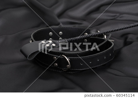 Stack for bdsm games and leather collar on black 60345114