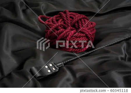 Stack for BDSM games and shibari rope on black 60345118