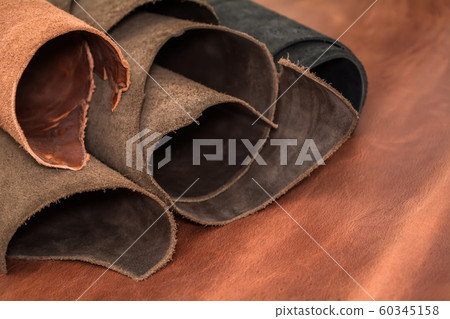 Rolls of natural brown and black leather. 60345158