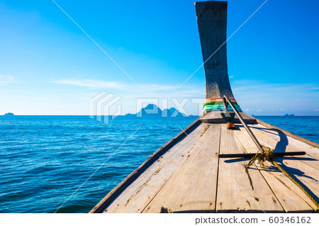 Longtail Boat In Sea At Aonang Beach Against Blue Sky Longtail Boat In Sea At Aonang Beach Against Blue Sky 60346162