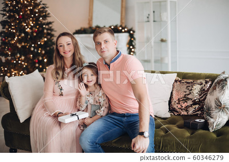 Smiling mother giving gift box to cute little 60346279