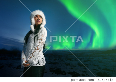 Girl in modern clothing on background of northern lights. Girl in modern clothing on background of northern lights. 60346718