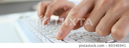 Male arms in suit typing on silver keyboard Male arms in suit typing on silver keyboard 60346941