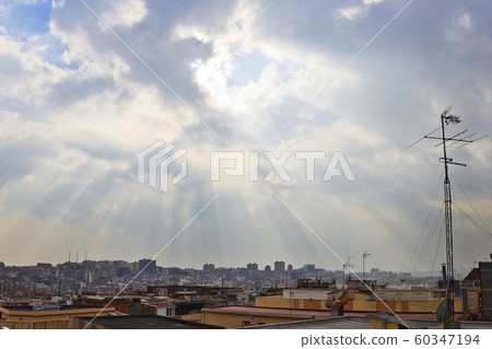 Sunrays through the clouds over Santa Coloma de 60347194