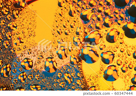 Drops Of Water Or Rain On Wet Glass Background. Moody Photo In Yellow And Blue Colors Drops Of Water Or Rain On Wet Glass Background. Moody Photo In Yellow And Blue Colors 60347444