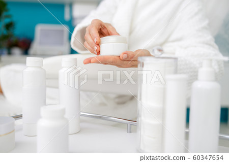 Close up of lady hands holding skin care product Close up of lady hands holding skin care product 60347654
