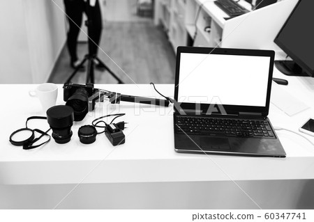 Notebook placed on desk accompaniment with the camera and steady cam Notebook placed on desk accompaniment with the camera and steady cam 60347741
