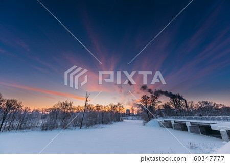 Dobrush, Gomel Region, Belarus. Old Paper Factory Tower In Winter Morning. Sun In Sunrise Over Historical Heritage Dobrush, Gomel Region, Belarus. Old Paper Factory Tower In Winter Morning. Sun In Sunrise Over Historical Heritage 60347777