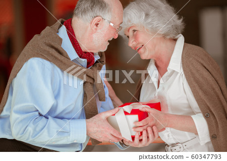 Senior Couple with Christmas Gift Senior Couple with Christmas Gift 60347793