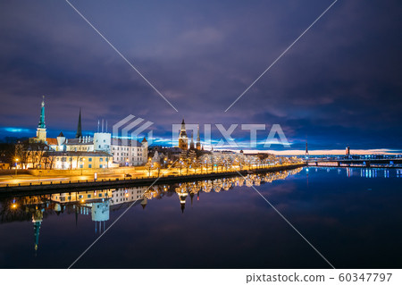Riga, Latvia, Europe. Cityscape In Morning Time. Night View Of Castle, Dome Cathedral And St. Peter's Church. Popular Place With Famous Landmarks. UNESCO. Old Town In Street Christmas Decoration Riga, Latvia, Europe. Cityscape In Morning Time. Night View Of Castle, Dome Cathedral And St. Peter's Church. Popular Place With Famous Landmarks. UNESCO. Old Town In Street Christmas Decoration 60347797