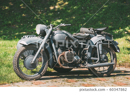 Old Tricar, Three-Wheeled Gray Motorcycle With A Sidecar Of German Forces Of World War 2 Time 60347862