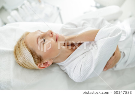 Smiling adult lady relaxing in beauty salon 60347888