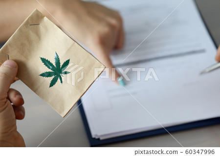 Male arm holding paper packet Male arm holding paper packet 60347996