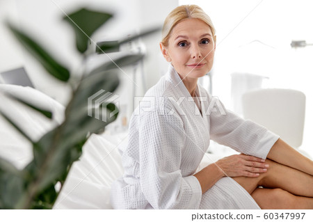 Smiling pretty lady looking at camera in beauty salon Smiling pretty lady looking at camera in beauty salon 60347997