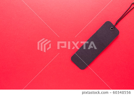 Black label on red isolated background close-up. Black label on red isolated background close-up. 60348556