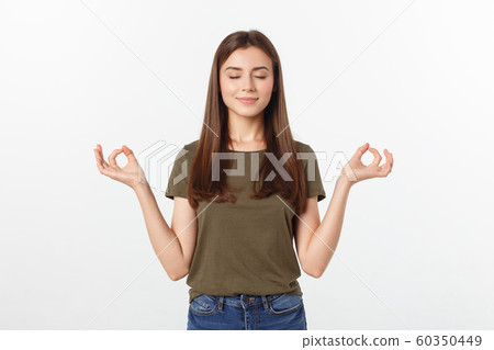 Beautiful young woman in yoga position and meditating isolated over gray background 60350449