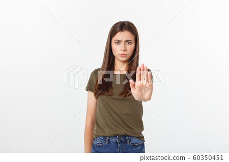 Portrait of young woman making stop sign in front of the camera. 60350451