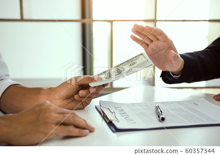 Business person refusing bribe given money by 60357344