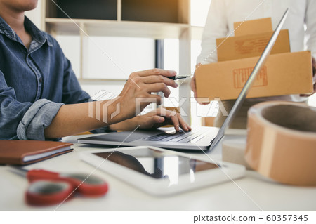 Two business owner are working together to pack Two business owner are working together to pack 60357345