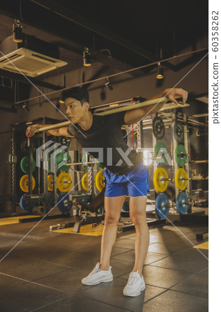 Male and female exercising in gym. Sport, fitness, weightlifting and training concept 195 60358262