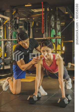 Male and female exercising in gym. Sport, fitness, weightlifting and training concept 137 Male and female exercising in gym. Sport, fitness, weightlifting and training concept 137 60358380