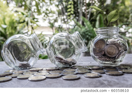 Glass jar piggy bank with coins. Plan your savings, run a growing business for success and save for retirement 60358610
