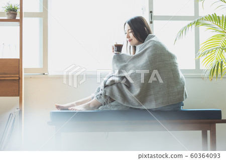 Young woman cold chilly teatime 60364093