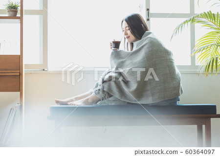 Young woman cold chilly teatime Young woman cold chilly teatime 60364097