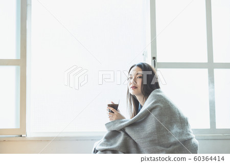 Young woman cold chilly teatime Young woman cold chilly teatime 60364414