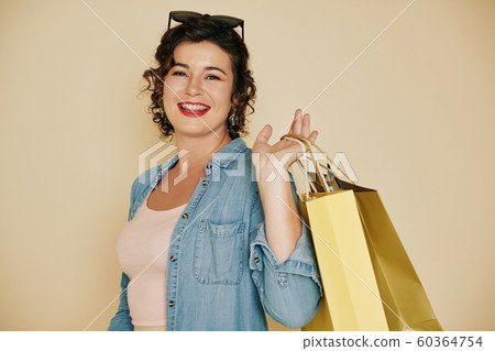 Woman posing with shopping bags Woman posing with shopping bags 60364754