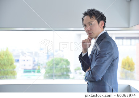 A businessman hitting his hands on his chin A businessman hitting his hands on his chin 60365974