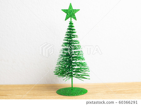 Green star on the top of Green Christmas tree and Green star on the top of Green Christmas tree and 60366291