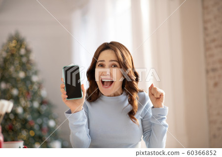 Beautiful young woman with long hair looking happy 60366852