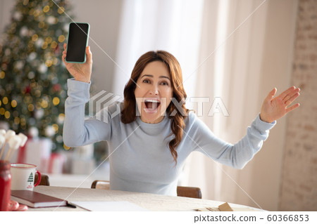 Dark-haired cute woman feeling great at home 60366853