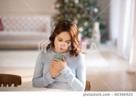 Young cute woman in grey homewesar typing a message Young cute woman in grey homewesar typing a message 60366920