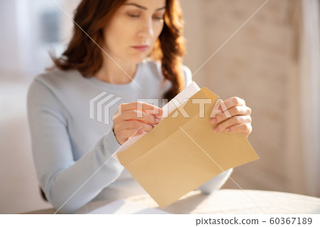 Pretty young woman with long hair looking worried 60367189