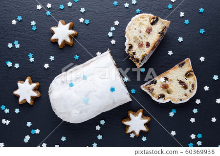 traditional german christmas cake stollen with cookies and decoration 60369938