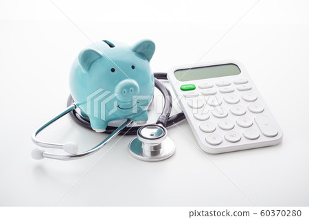Piggy bank with stethoscope and calculator 60370280